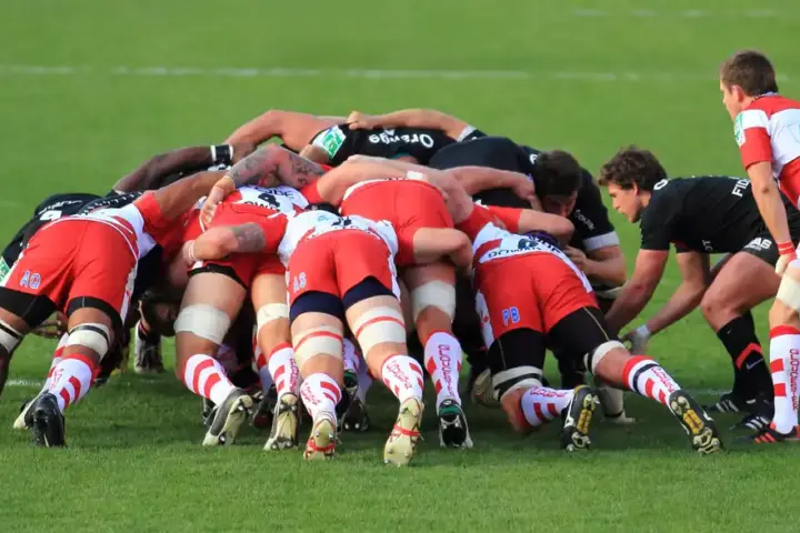 Rugby union forwards contesting a set-piece on a grass pitch.