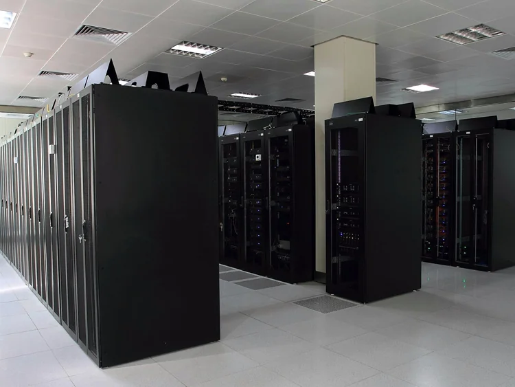 Rows of dark server racks in a bright data-centre aisle