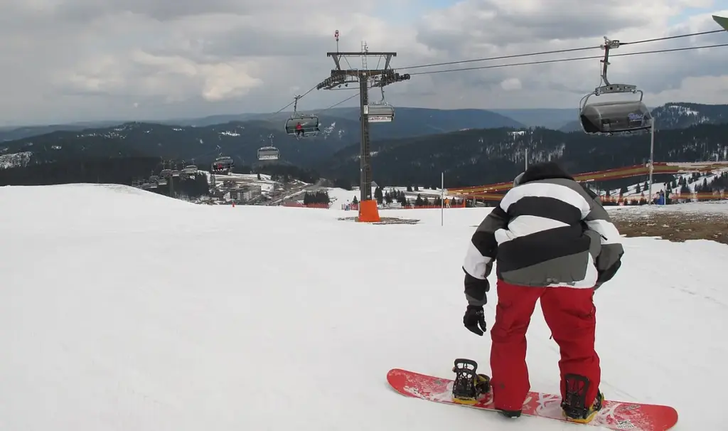 A snowboarder performing a jump during a winter sports event.