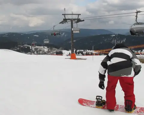 A snowboarder performing a jump during a winter sports event.