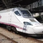 Renfe high-speed train on railway tracks at a Spanish station