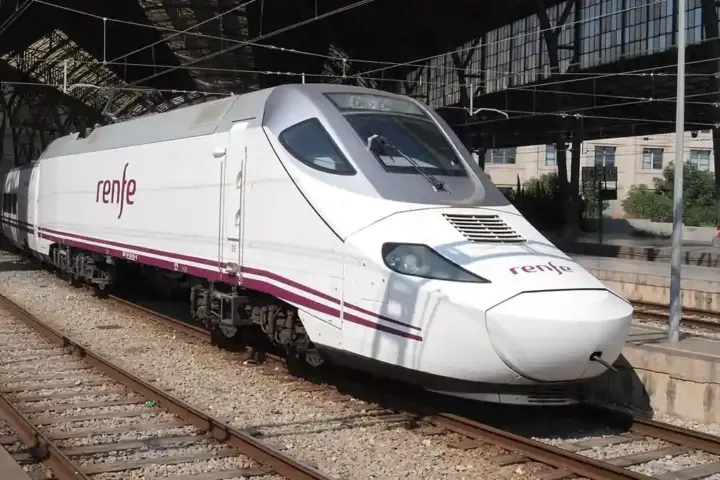 Renfe high-speed train on railway tracks at a Spanish station