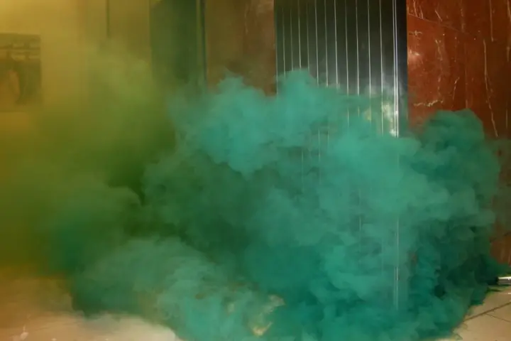 University students protesting with smoke bombs and banners during a campus demonstration