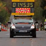 A dense pack of marathon runners racing along a closed city street in Dublin, Ireland.