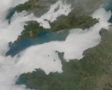 Low cloud cover stretches across the English Channel in a satellite-style atmospheric view.