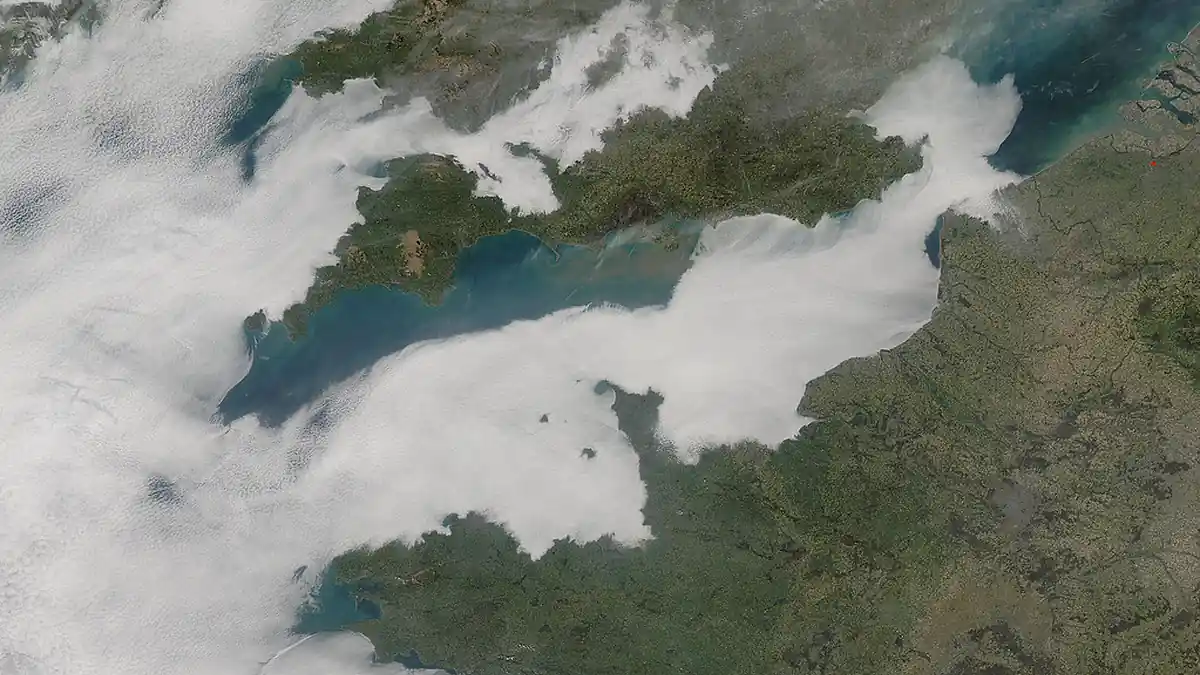 Low cloud cover stretches across the English Channel in a satellite-style atmospheric view.