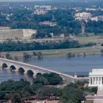 Historical documentary photograph showing the eastern span of the Arlington Memorial Bridge over the Potomac River connecting Washington D.C. to Virginia.