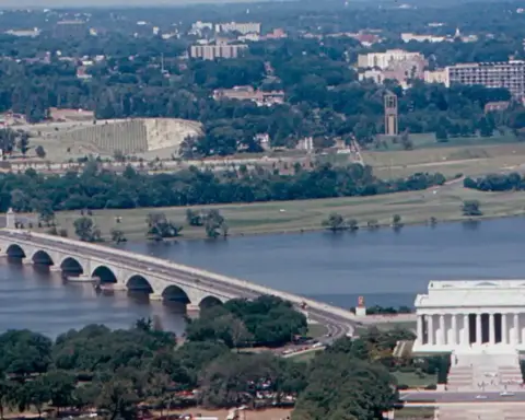 Historical documentary photograph showing the eastern span of the Arlington Memorial Bridge over the Potomac River connecting Washington D.C. to Virginia.
