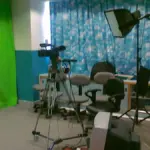 A professional television studio camera is positioned for a live broadcast.