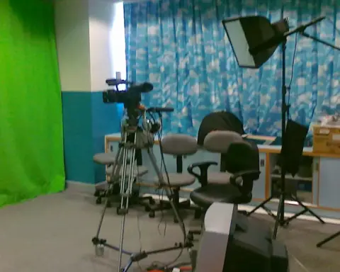 A professional television studio camera is positioned for a live broadcast.