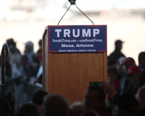 Donald Trump speaks from a podium at a campaign-style event.
