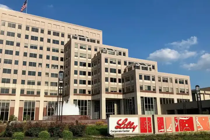 Exterior view of the Eli Lilly corporate center campus in Indianapolis, Indiana, with its entrance and landscaped grounds.