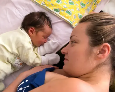 Human photograph of a mother holding a newborn infant.