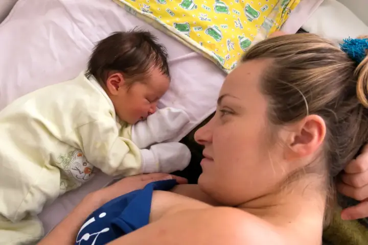 Human photograph of a mother holding a newborn infant.