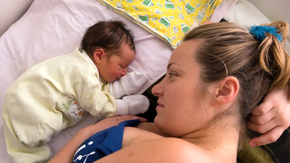 Human photograph of a mother holding a newborn infant.