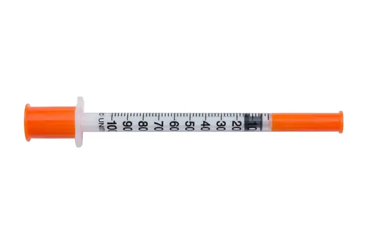 A medical syringe photographed against a plain background.
