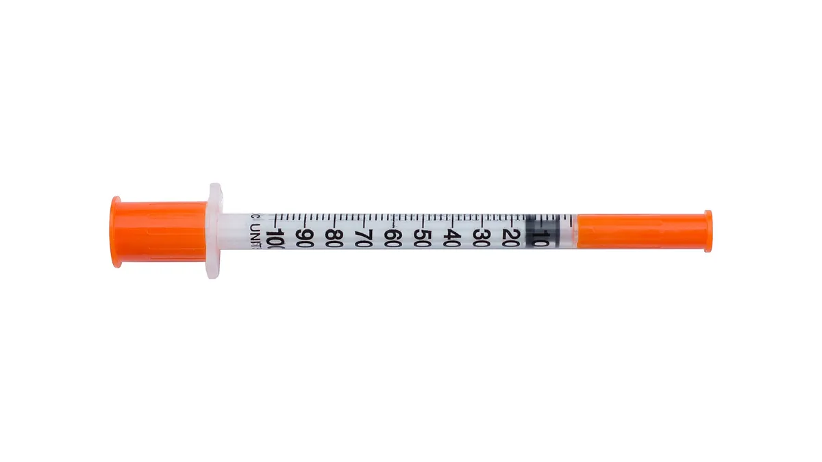 A medical syringe photographed against a plain background.