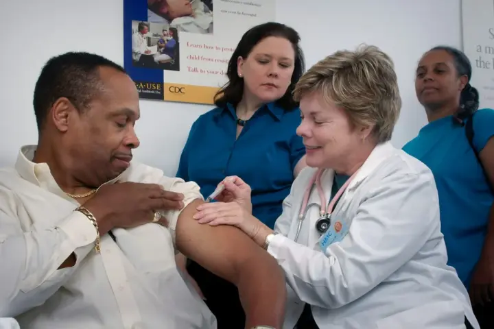 Older adult reviewing healthcare documents at a table