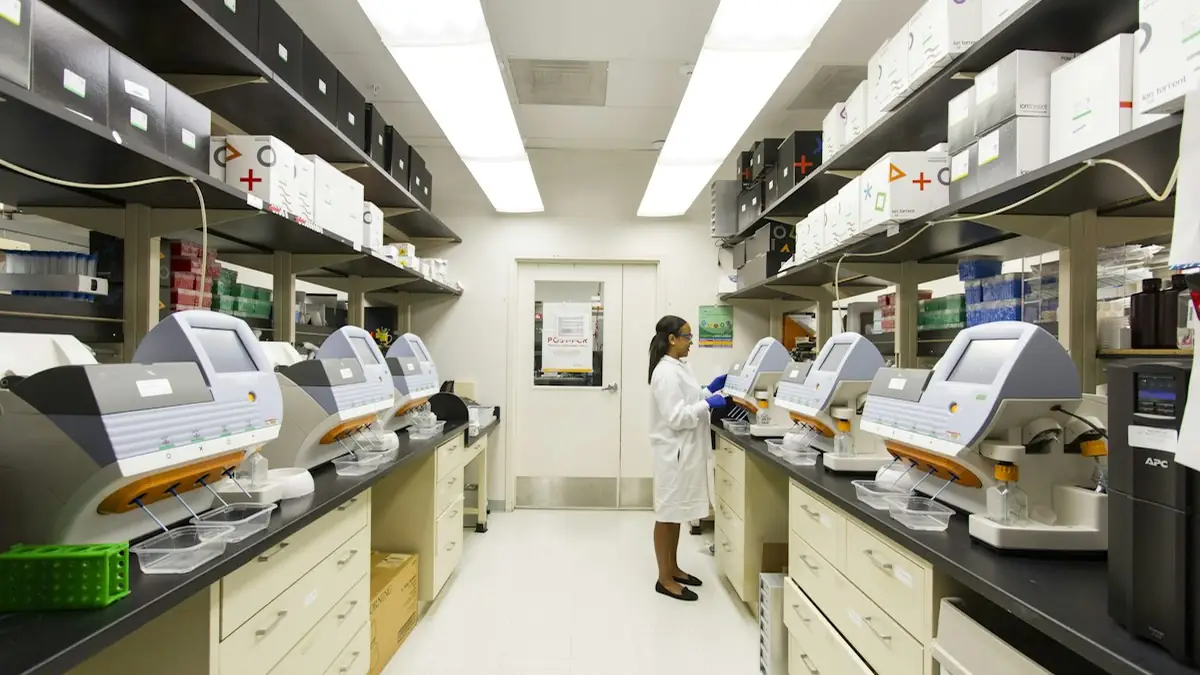 Laboratory technician preparing oncology samples in a clinical trial facility evaluating androgen receptor inhibitors