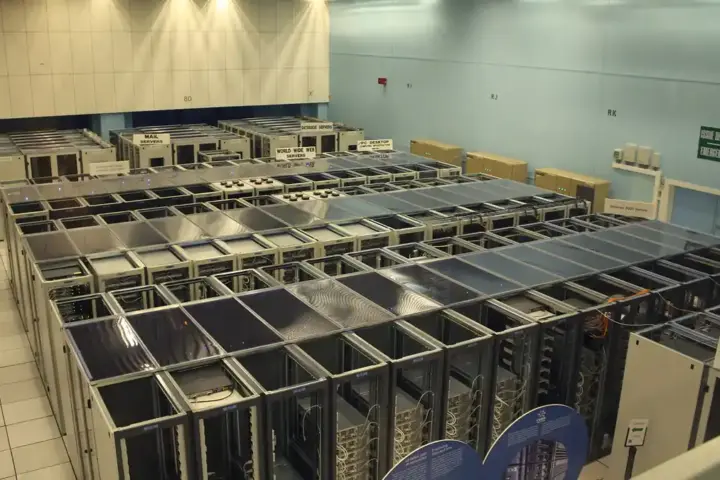 Long rows of server racks inside a data center hall.