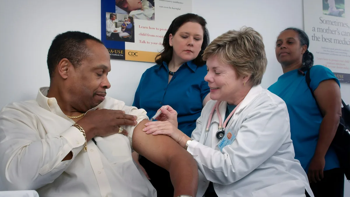 Older adult reviewing healthcare documents at a table