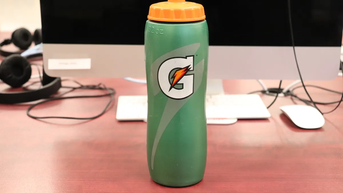 Rows of 28-ounce Gatorade sports drink bottles arranged on a retail store shelf.