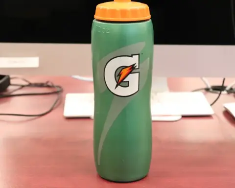 Rows of 28-ounce Gatorade sports drink bottles arranged on a retail store shelf.