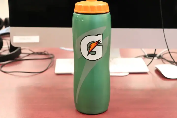 Rows of 28-ounce Gatorade sports drink bottles arranged on a retail store shelf.