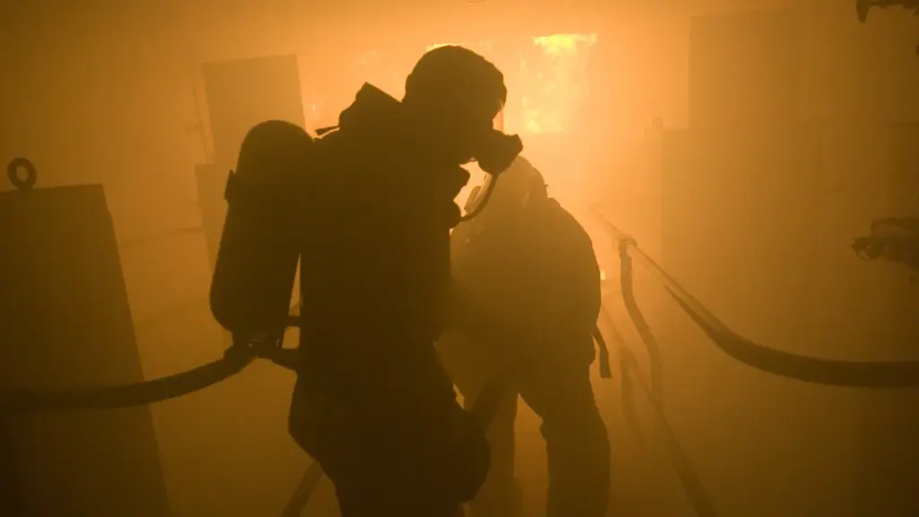 Sailors in protective gear spray aqueous film-forming foam during a firefighting training exercise