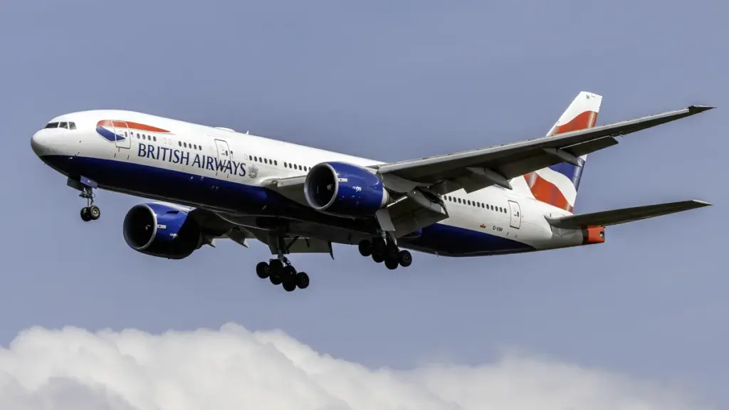 A British Airways Boeing 777-200ER widebody jetliner descending in clear skies.