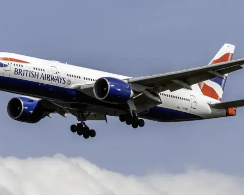 A British Airways Boeing 777-200ER widebody jetliner descending in clear skies.