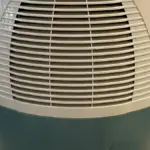 A household air dehumidifier unit with a European plug, illustrating the condensation technology atmospheric water generators rely on