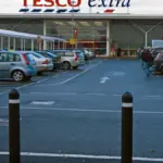 Exterior view of a large Tesco supermarket entrance in the United Kingdom