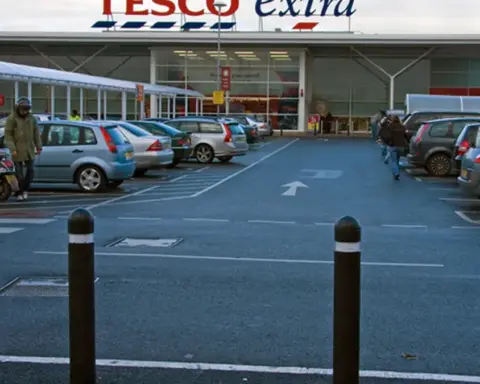 Exterior view of a large Tesco supermarket entrance in the United Kingdom