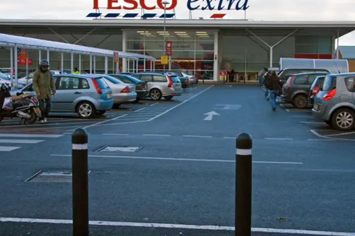Exterior view of a large Tesco supermarket entrance in the United Kingdom