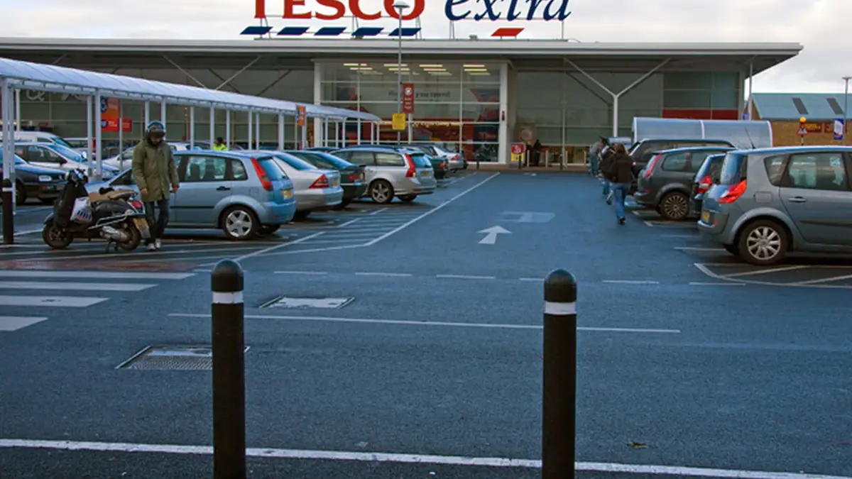 Exterior view of a large Tesco supermarket entrance in the United Kingdom