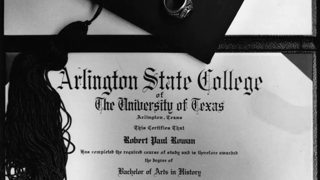 A formal university graduation diploma rolled with a ribbon alongside an academic graduation cap.