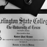 A formal university graduation diploma rolled with a ribbon alongside an academic graduation cap.
