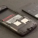 A smartphone with its rear cover detached, showing the removable battery compartment design that EU rules will soon require industry-wide