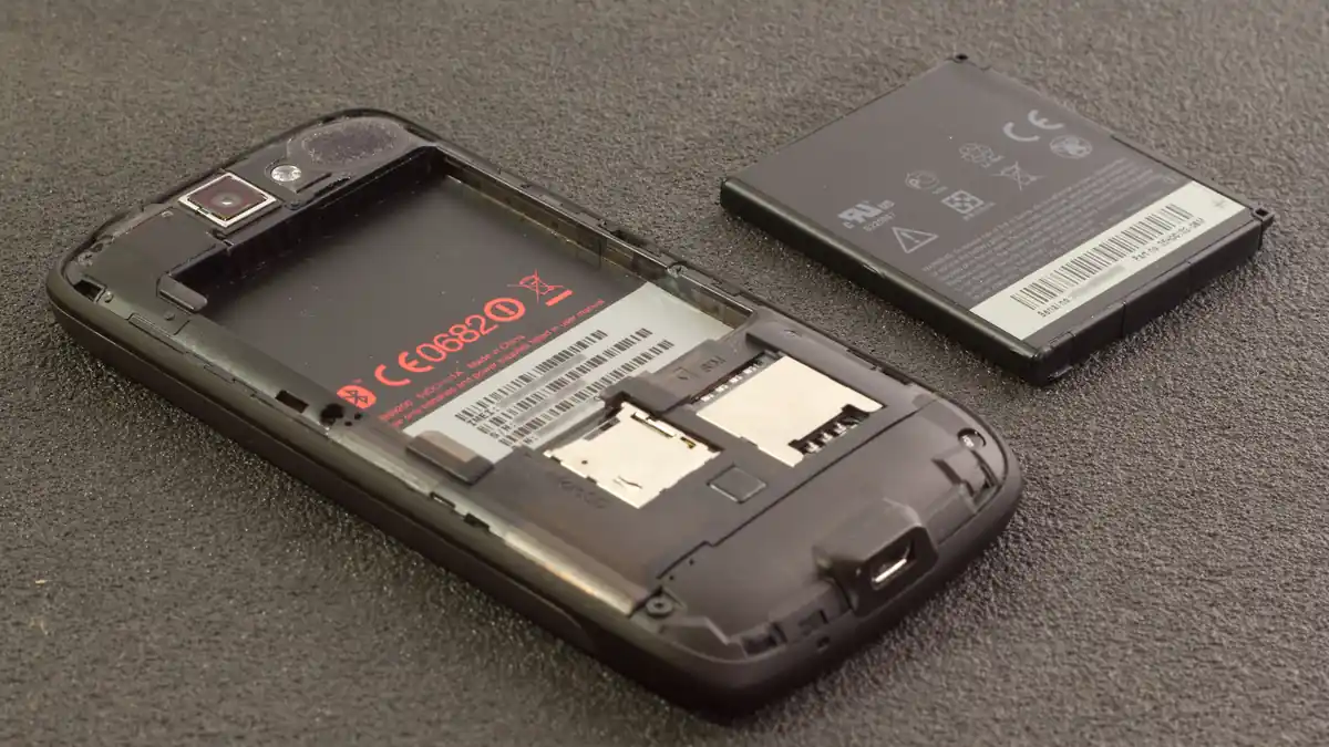 A smartphone with its rear cover detached, showing the removable battery compartment design that EU rules will soon require industry-wide