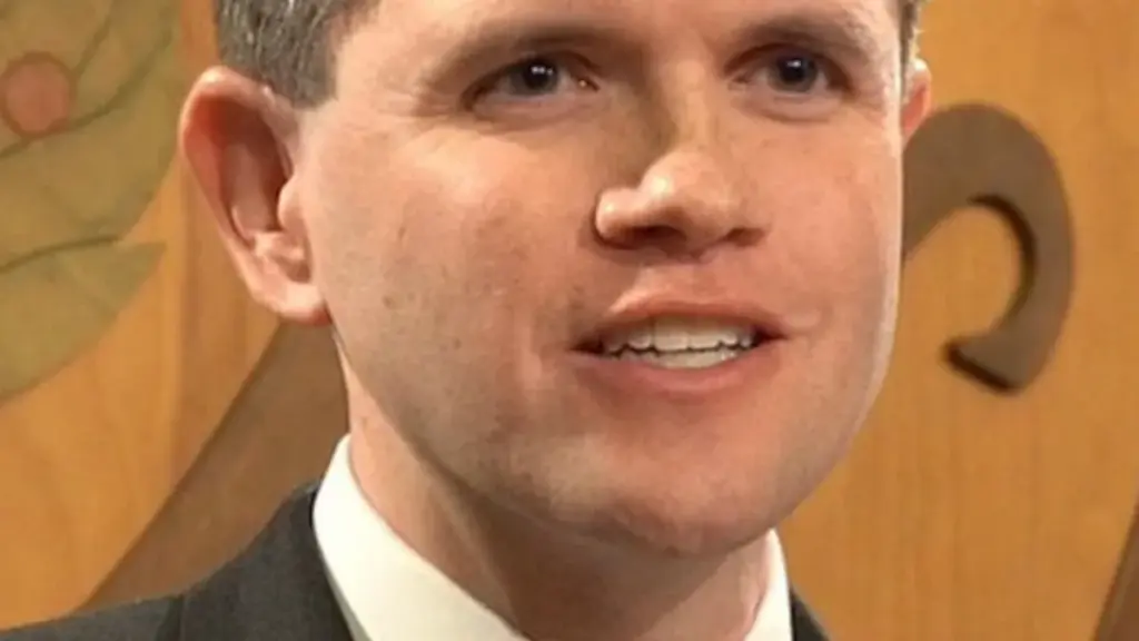 James Talarico speaking into microphones during an official legislative press conference at the Texas State Capitol.