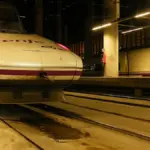Renfe high-speed passenger train beside a boarding platform at Madrid Puerta de Atocha railway station in Spain.