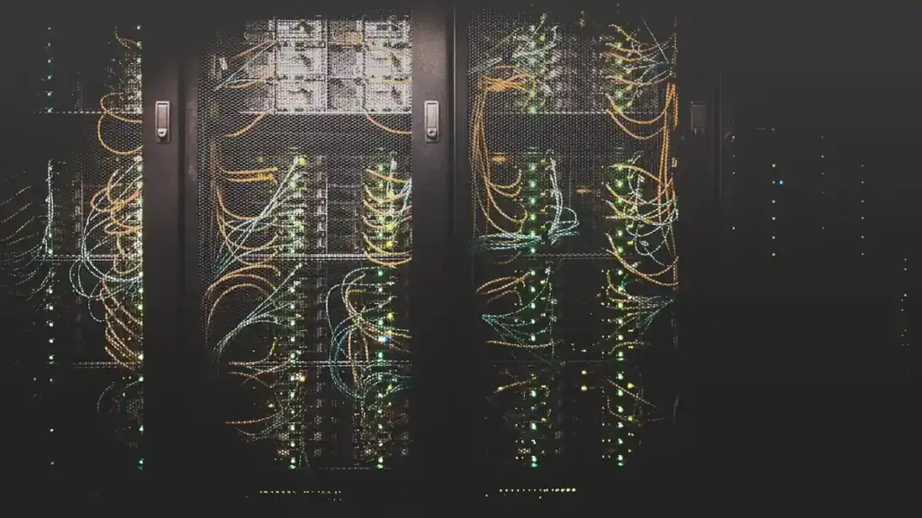 Rows of illuminated server racks in a data center