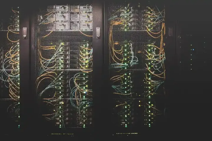 Rows of illuminated server racks in a data center