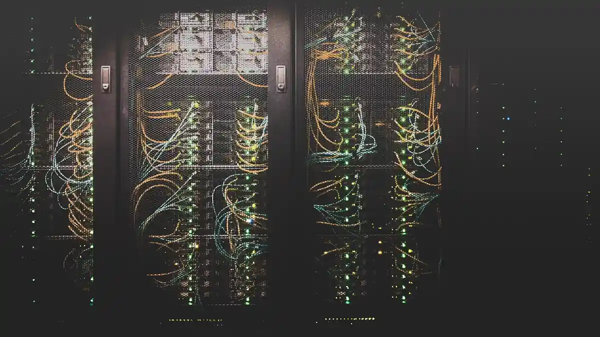 Rows of illuminated server racks in a data center