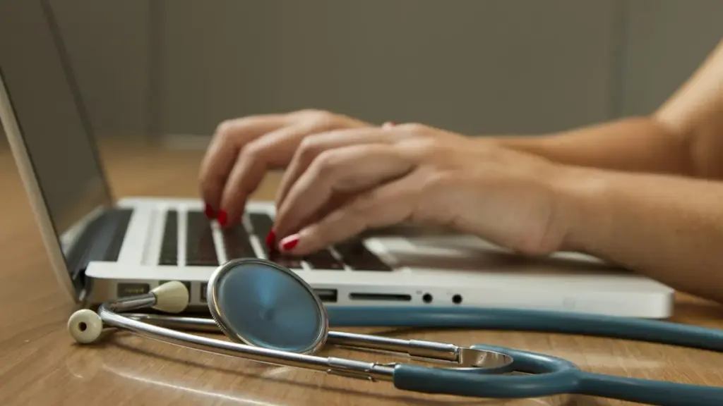 Healthcare professional consulting with an adult patient during a clinical neurology evaluation