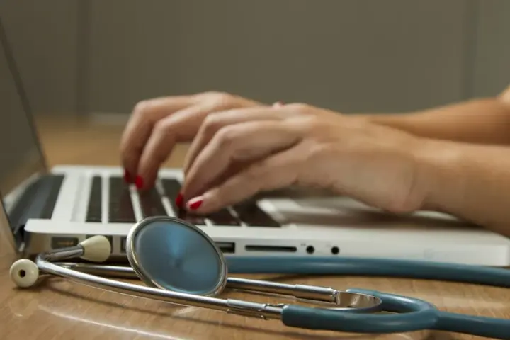 Healthcare professional consulting with an adult patient during a clinical neurology evaluation