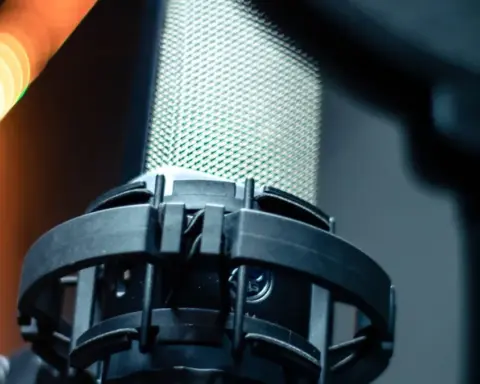 Close-up of a professional studio microphone and pop filter used for voice recording.