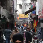 Commercial street scene with vehicles and storefronts in Amritsar Punjab