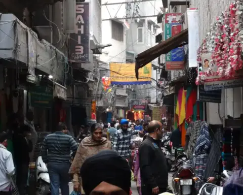 Commercial street scene with vehicles and storefronts in Amritsar Punjab